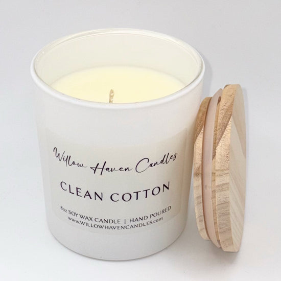 White candle with wooden lid labeled 'Willow Haven Candles Clean Cotton' on a light gray background