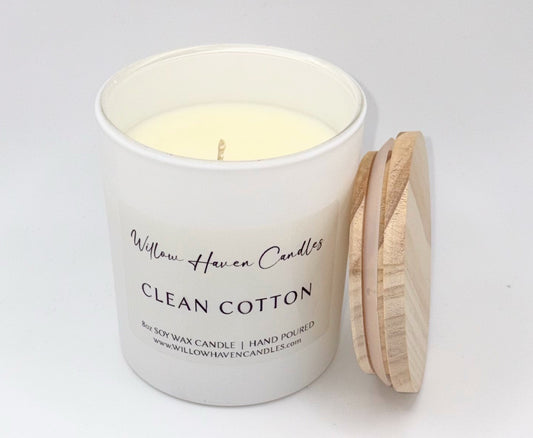 White candle with wooden lid labeled 'Willow Haven Candles Clean Cotton' on a light gray background